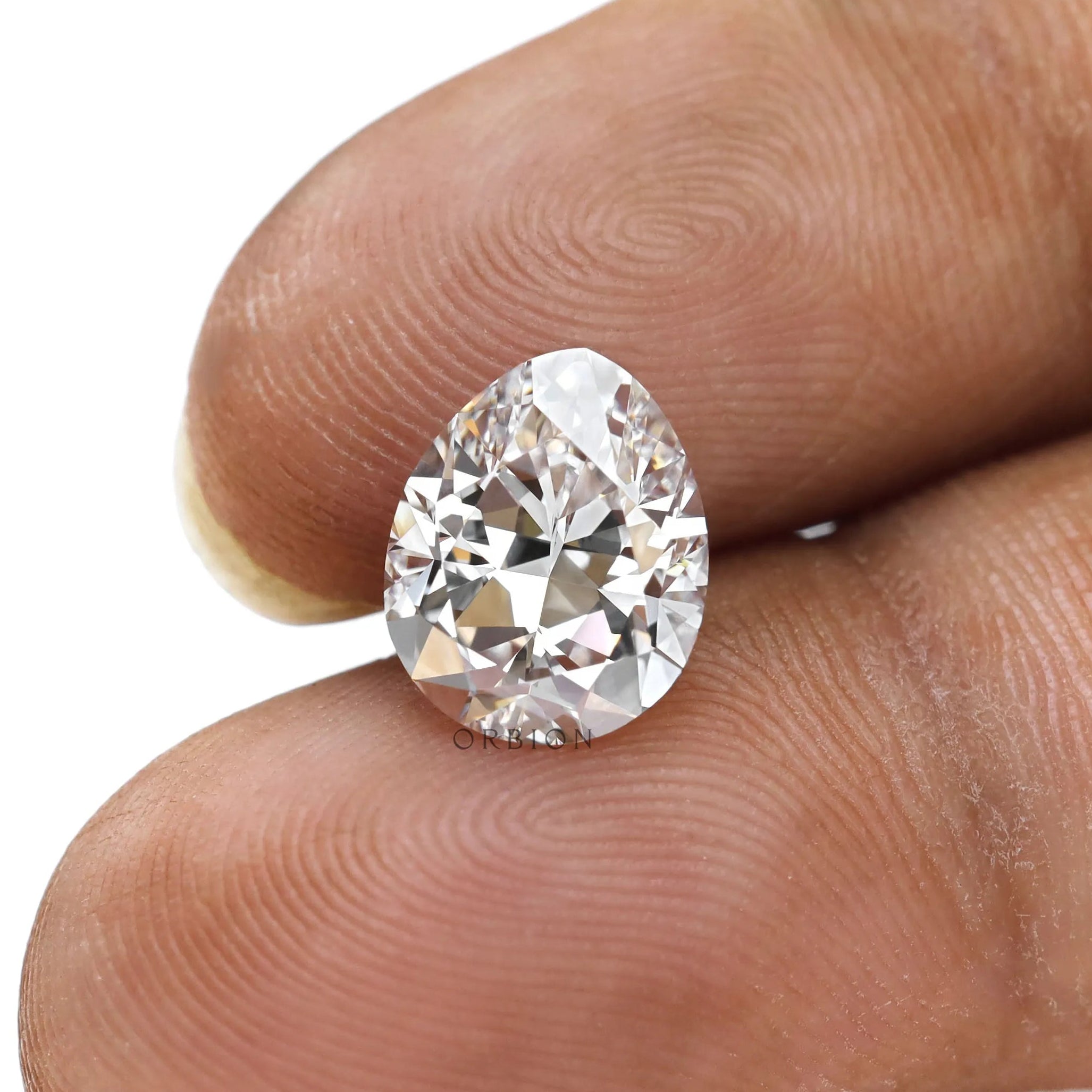 Pear brilliant cut loose lab diamond displayed on fingertips
