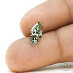 Fancy vivid green marquise lab diamond shown on fingertip