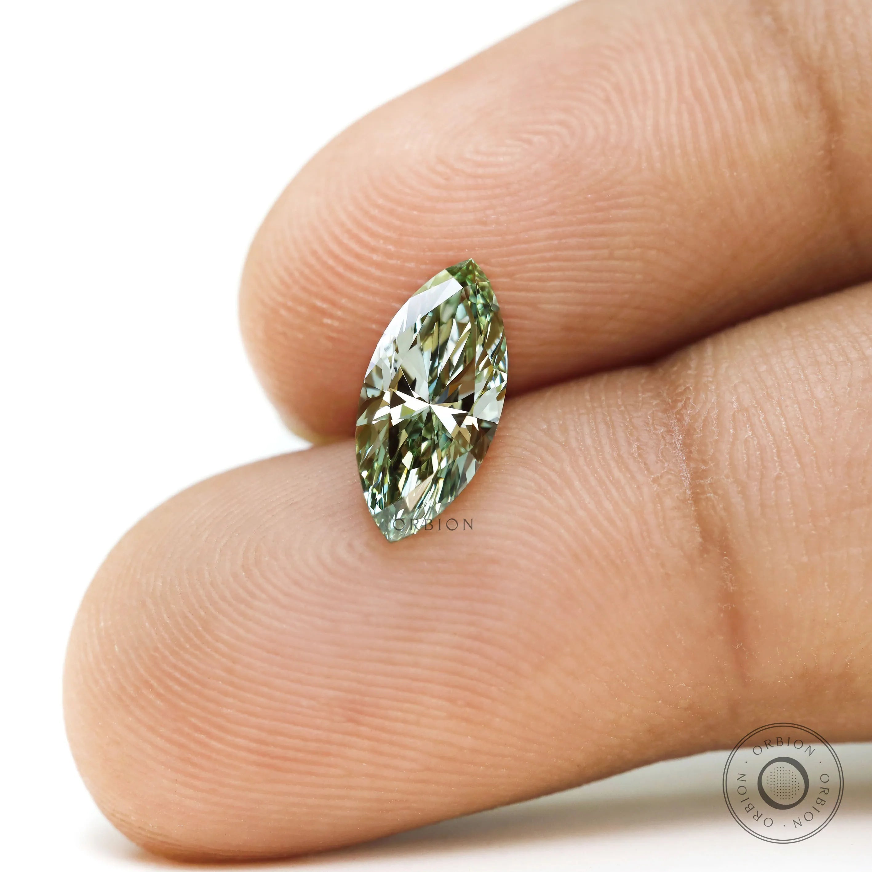 Fancy vivid green marquise lab diamond shown on fingertip