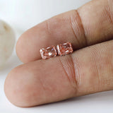 Macro fingertip view of matching pink radiant pair