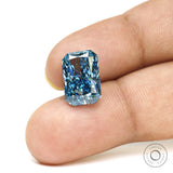 Fancy vivid blue radiant lab diamond shown on fingertips