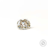 Side resting view of elongated cushion old mine moissanite