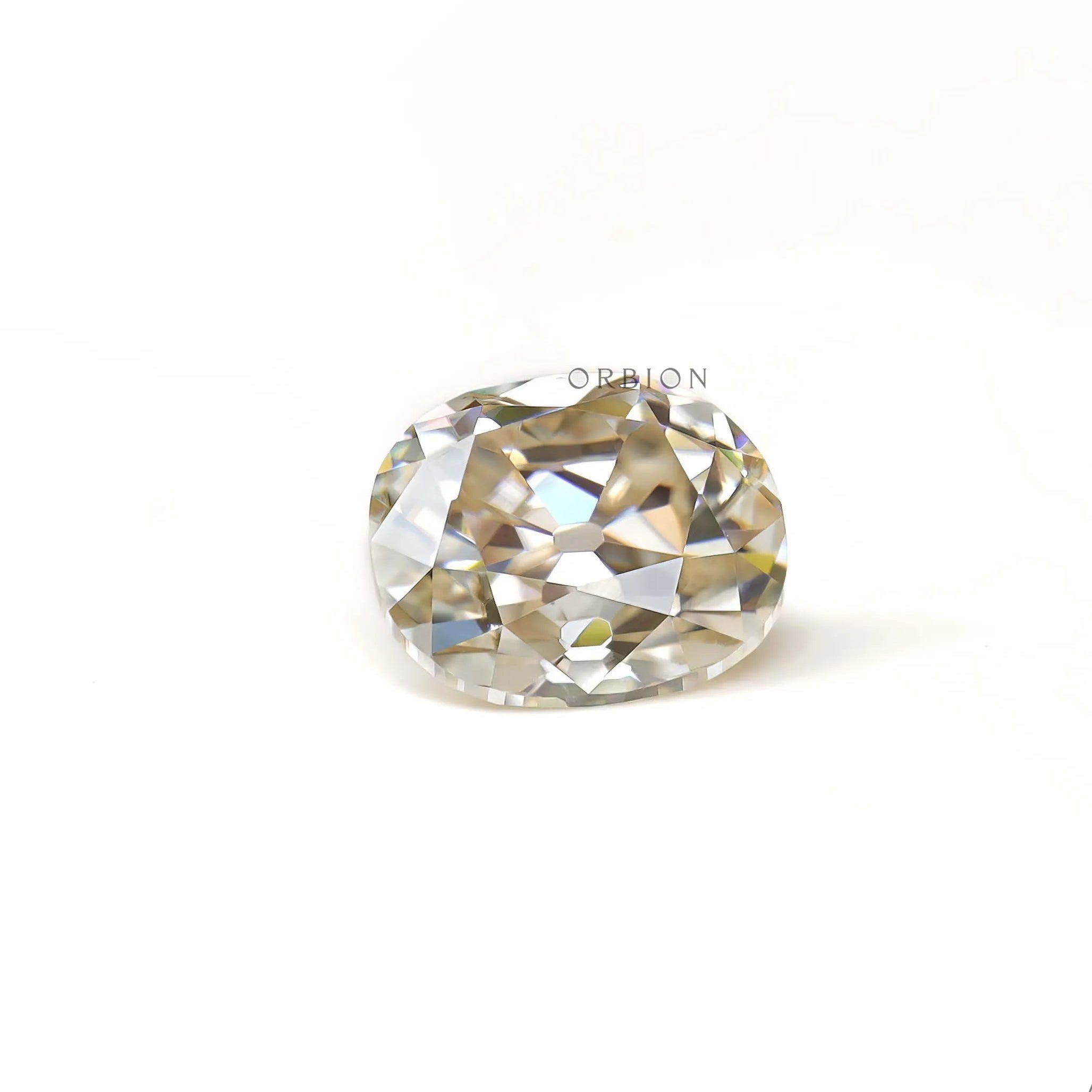 Side resting view of elongated cushion old mine moissanite