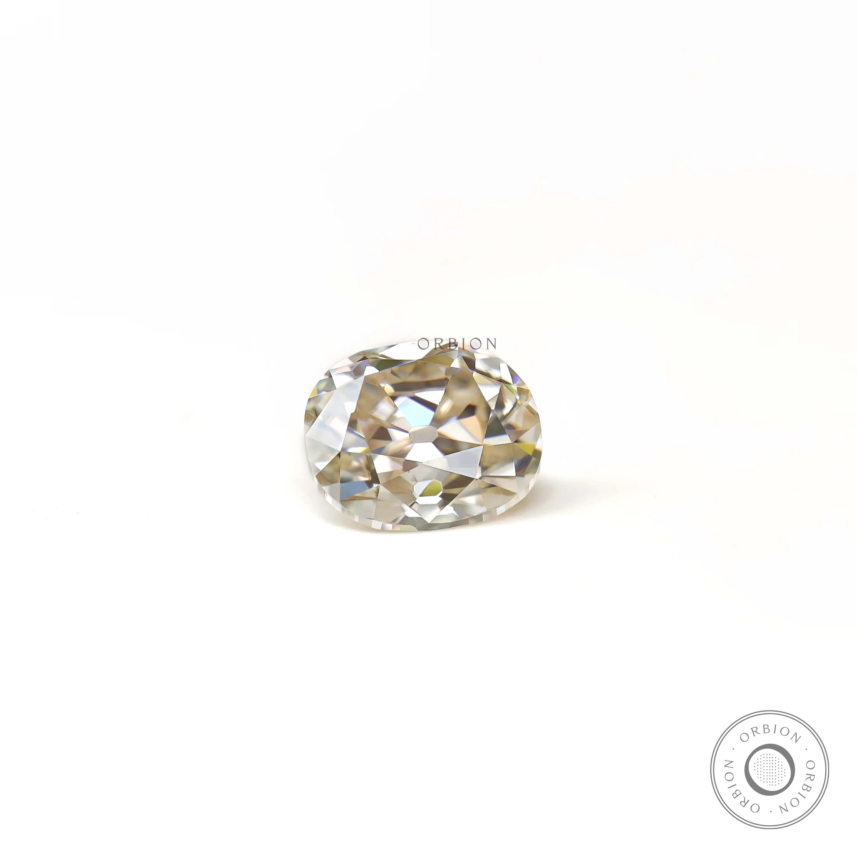 Side resting view of elongated cushion old mine moissanite