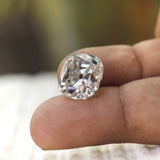 Large elongated cushion moissanite displayed on fingertip closeup