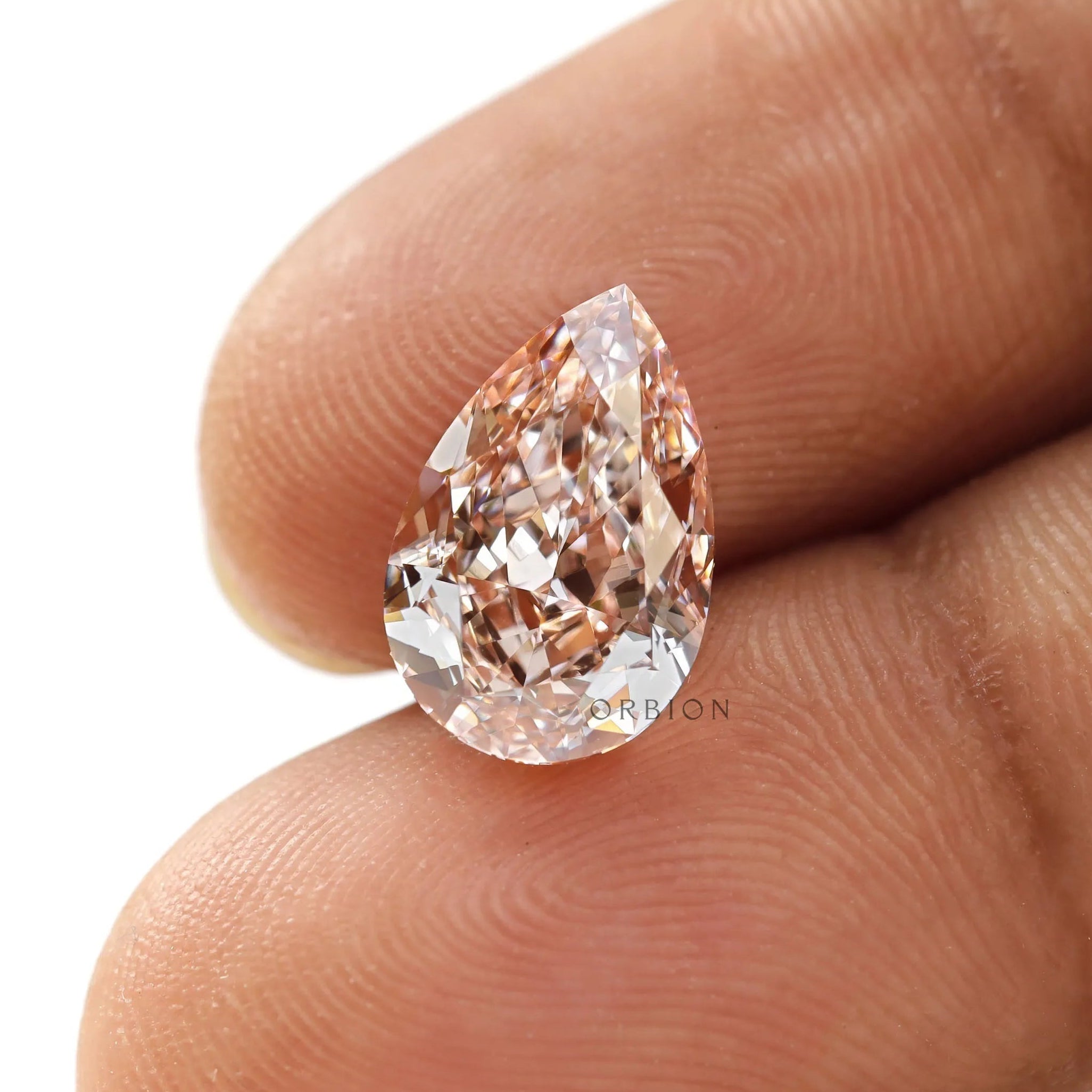 Fancy vivid pink pear loose lab diamond on fingertip