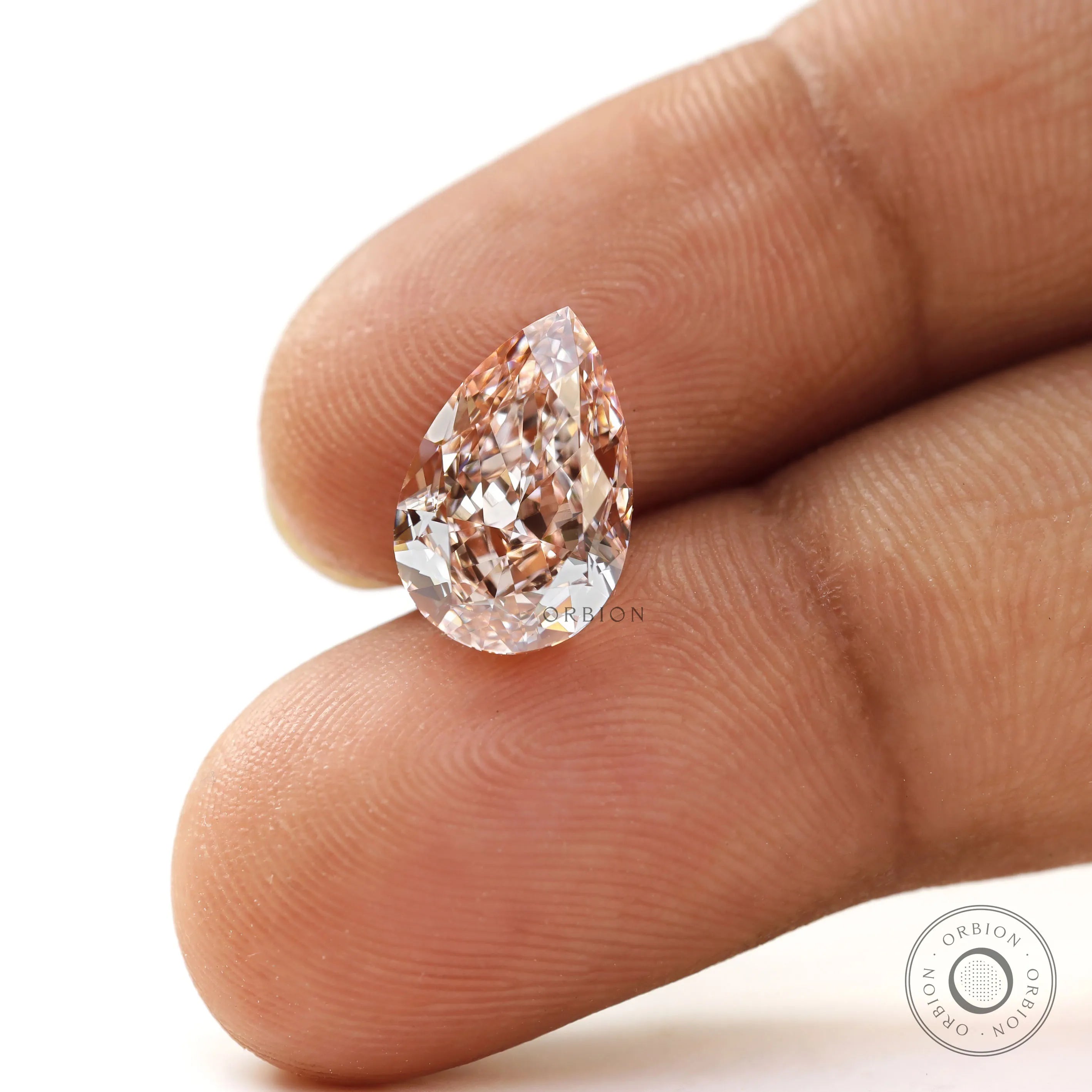 Fancy vivid pink pear loose lab diamond on fingertip