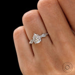 Moissanite engagement ring with leaf engravings on white gold band