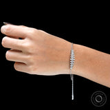 Adjustable bolo clasp with dangling diamond accents on solid gold bracelet