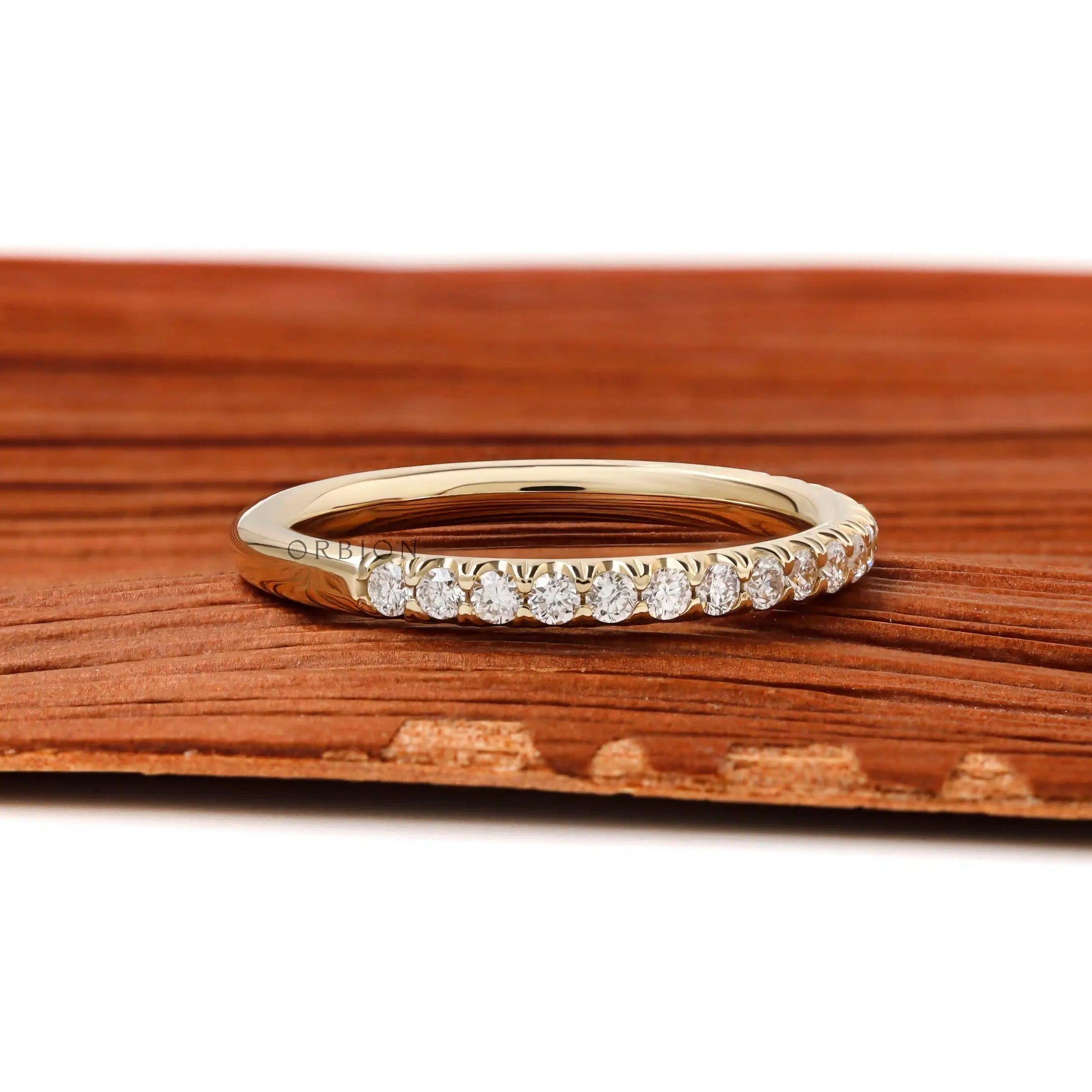 Close up of 1.5mm round brilliant lab diamonds in yellow gold band