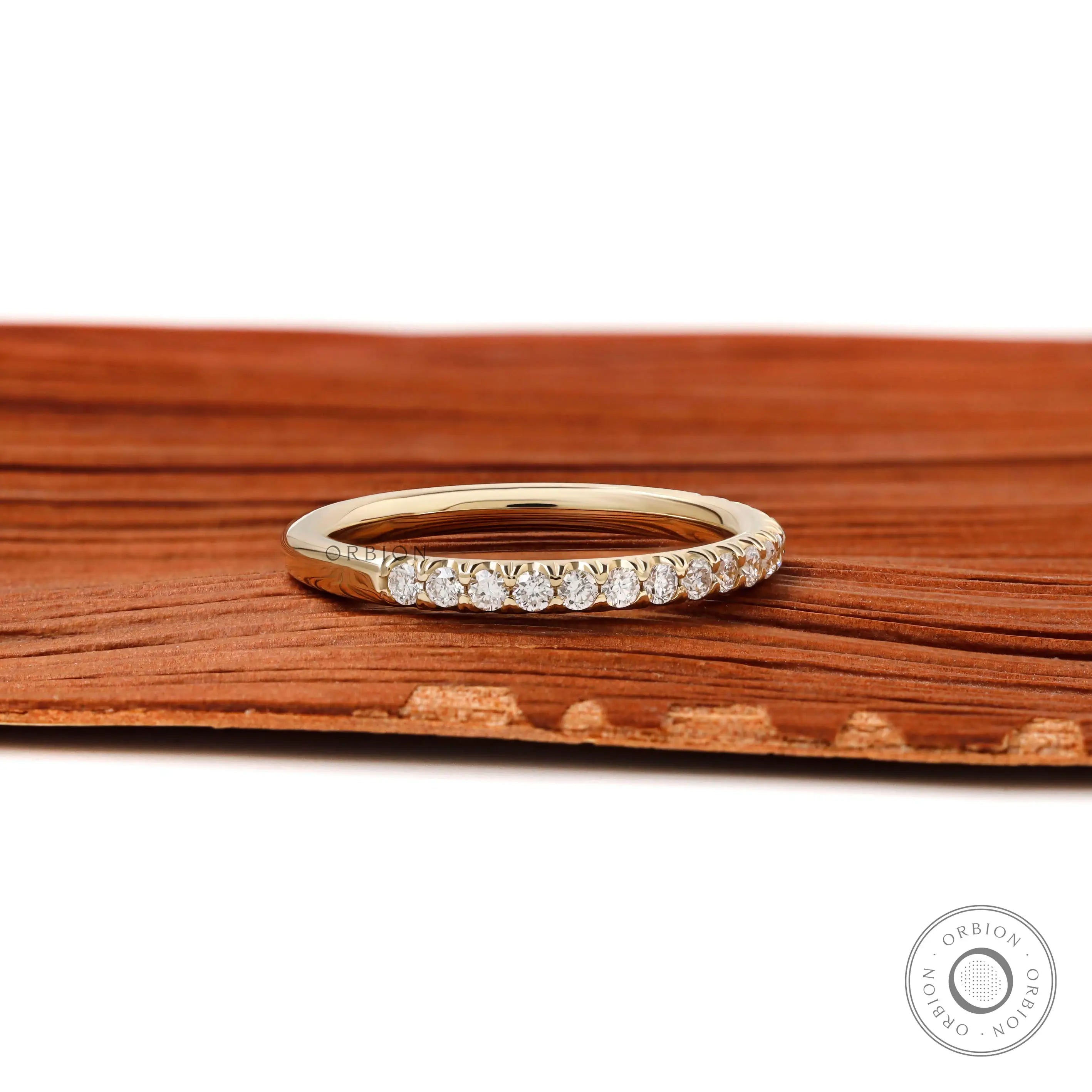 Close up of 1.5mm round brilliant lab diamonds in yellow gold band