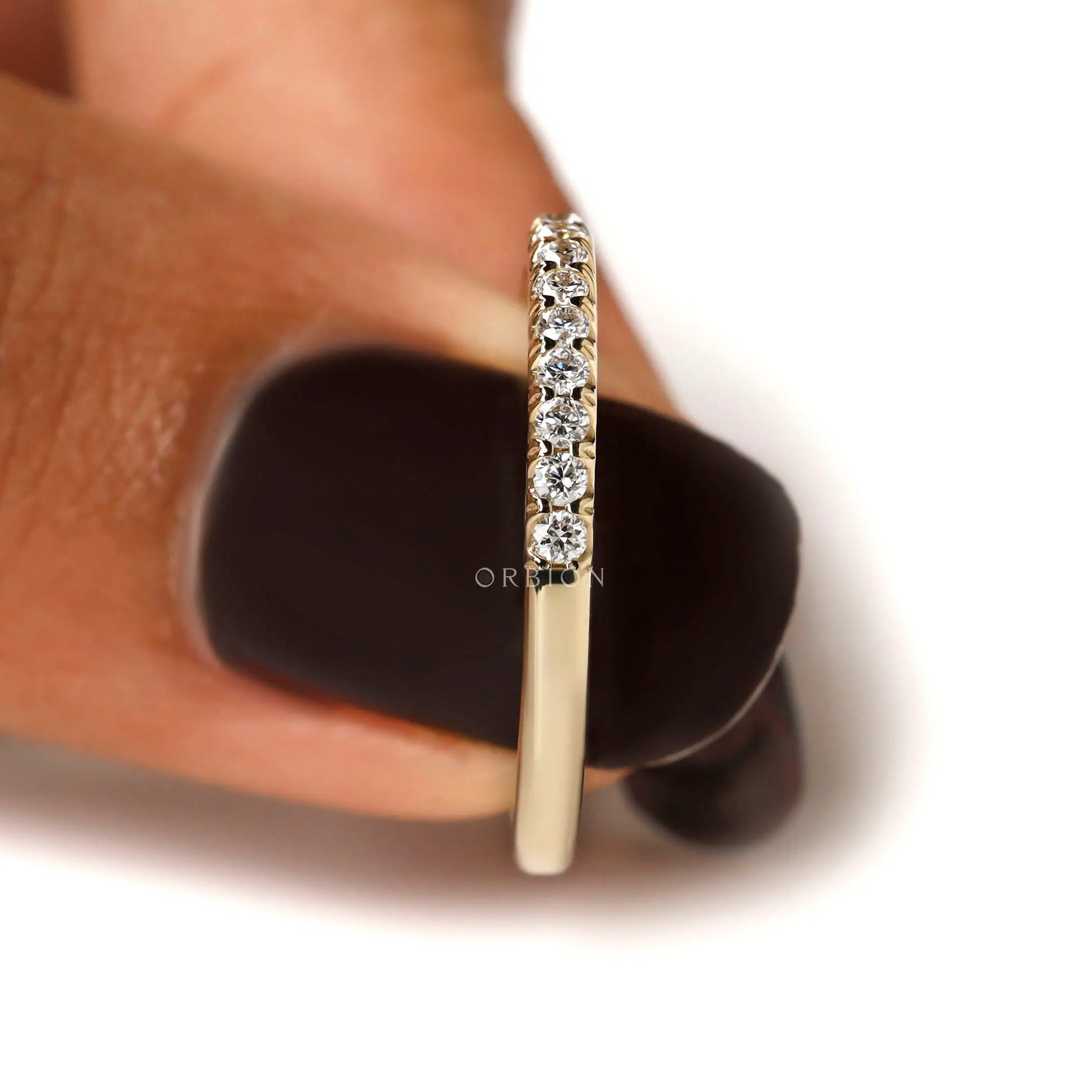 Side profile of half eternity round diamond band in yellow gold
