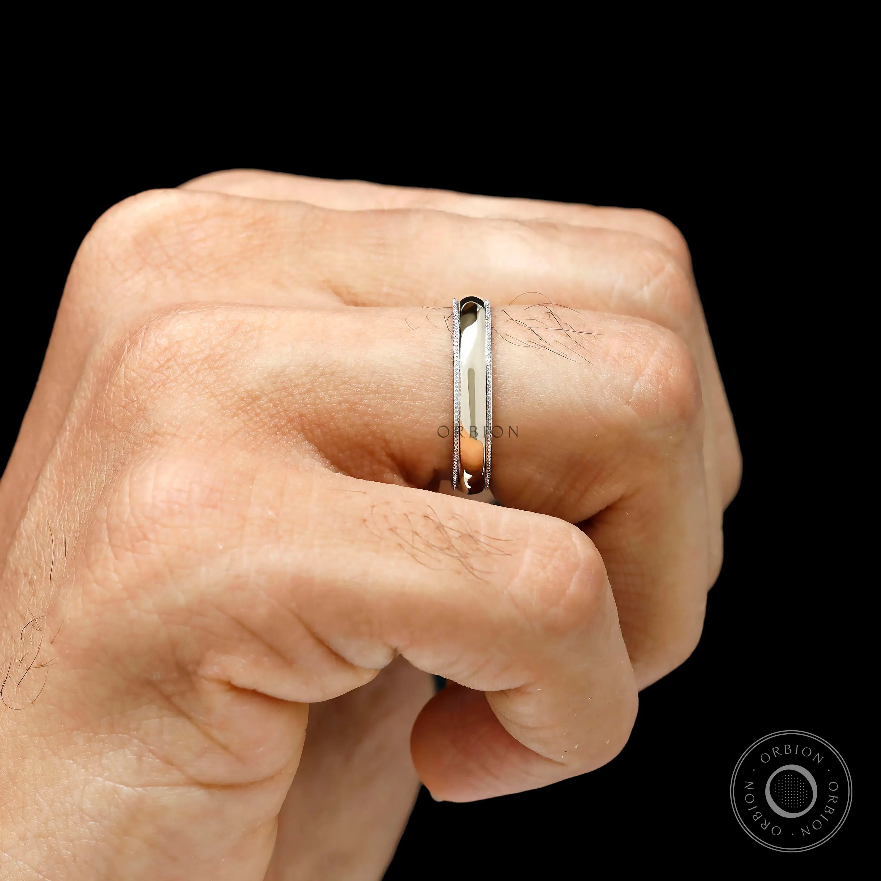 Hand wearing mens milgrain wedding band two tone gold