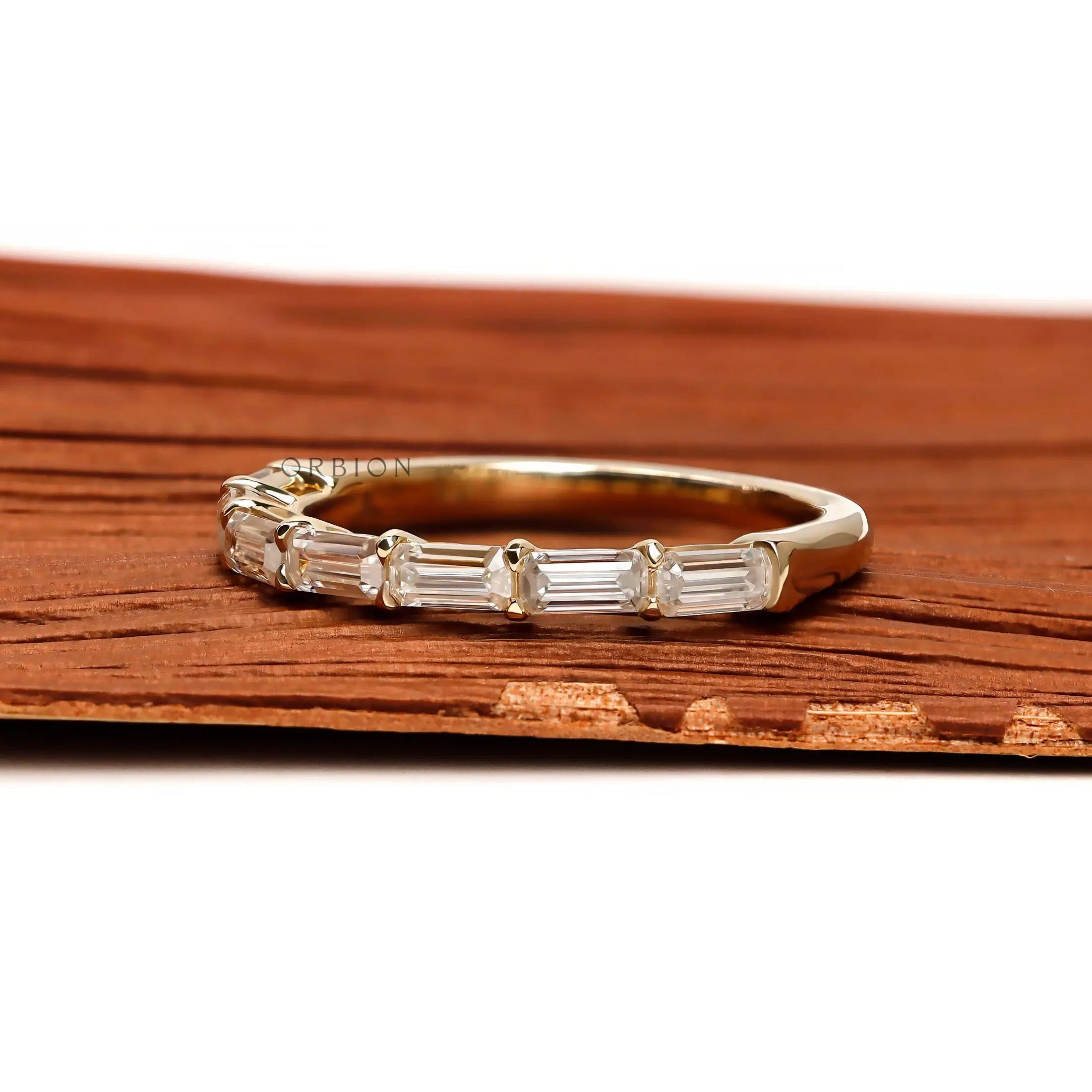 Elegant emerald cut moissanite band worn on finger