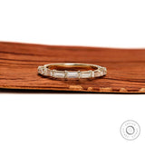 Close up emerald step cut half eternity band ring yellow gold