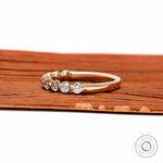 Side profile view of round lab diamond shared prong half eternity wedding band