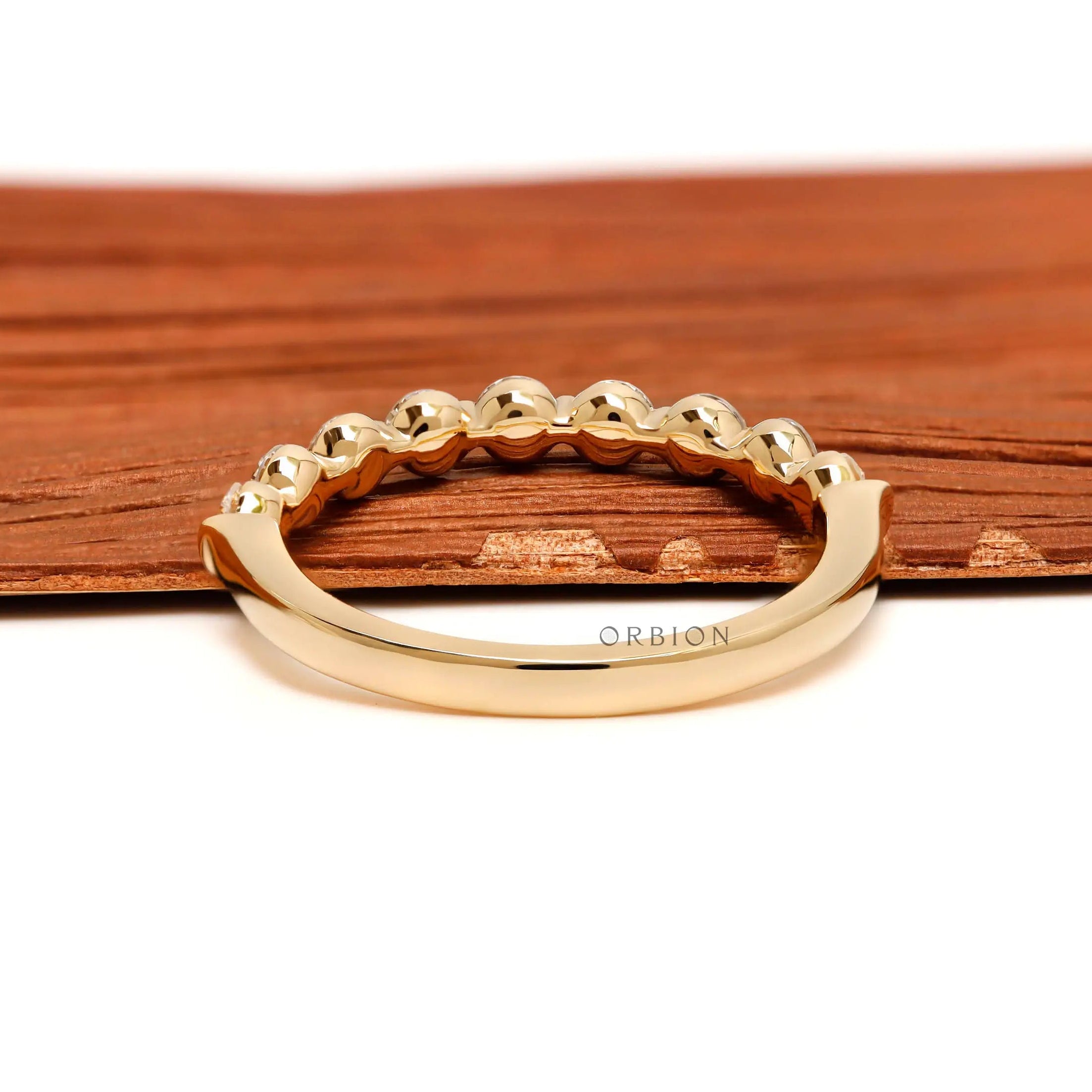 Back view of round lab diamond shared prong half eternity wedding band