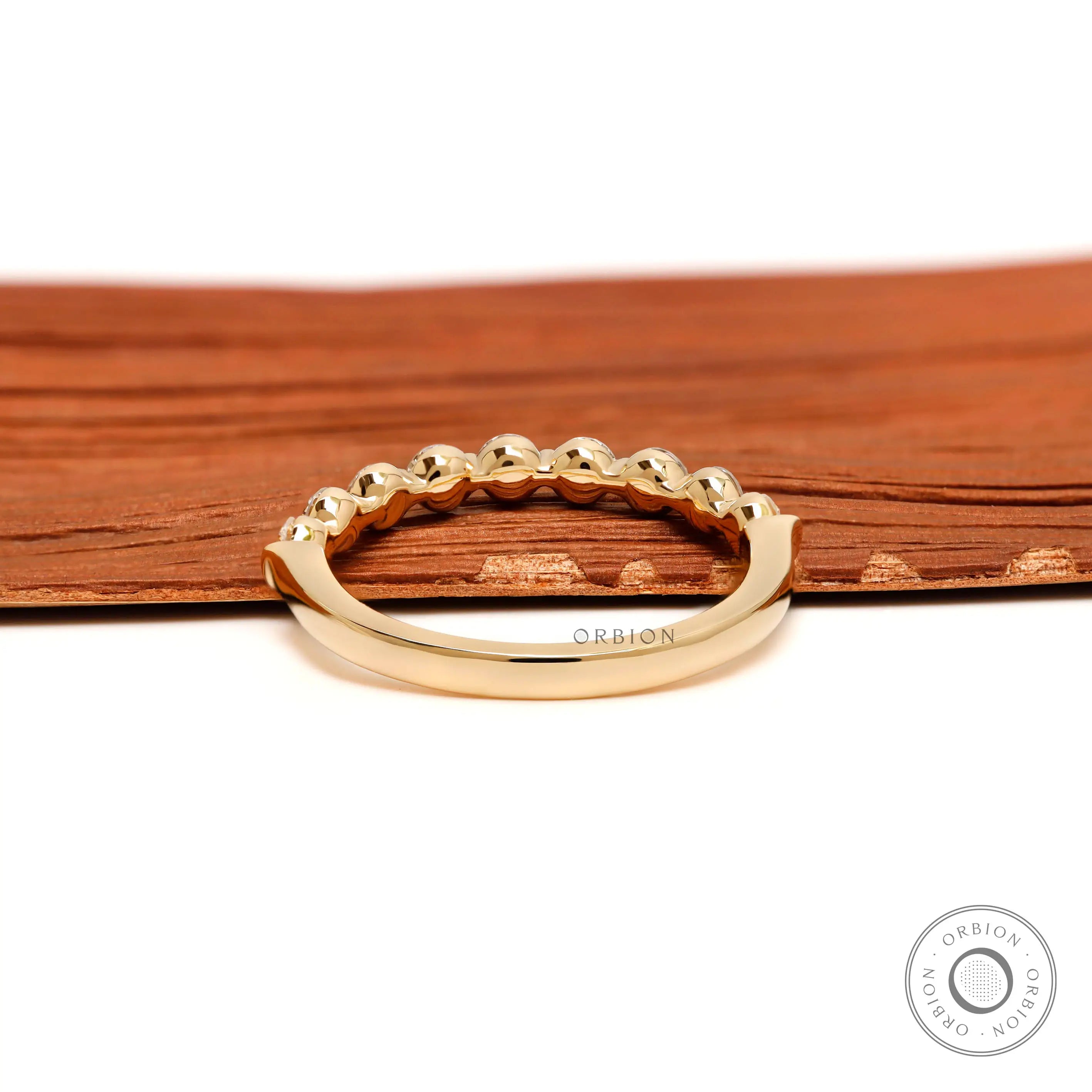 Back view of round lab diamond shared prong half eternity wedding band