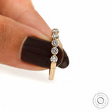 Vertical side detail view of round lab diamond shared prong half eternity band