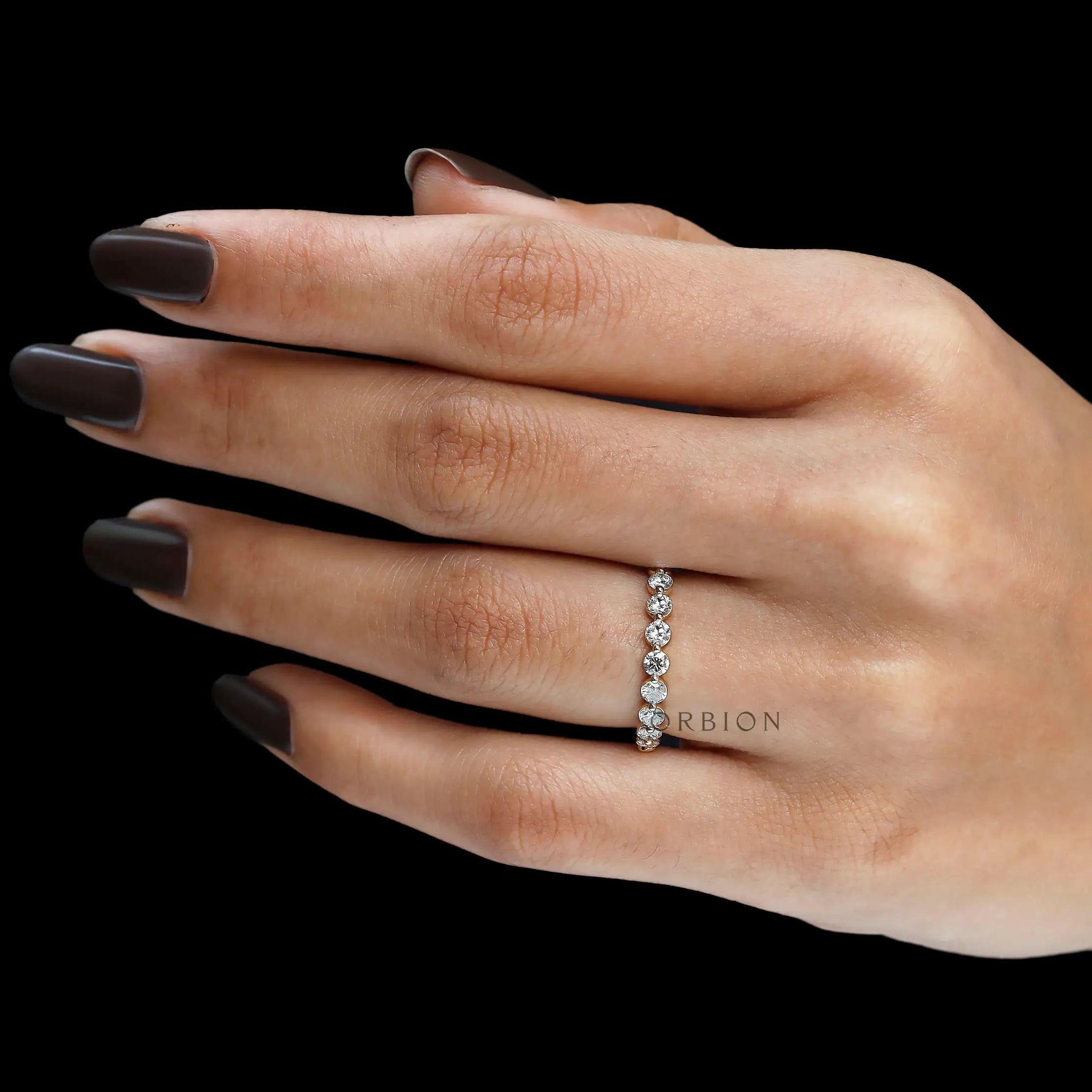 Side hand view of round lab diamond shared prong half eternity band