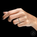 Top hand view of round lab diamond shared prong half eternity band