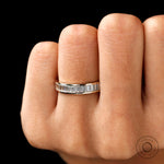 Channel set baguette moissanite eternity band worn on hand
