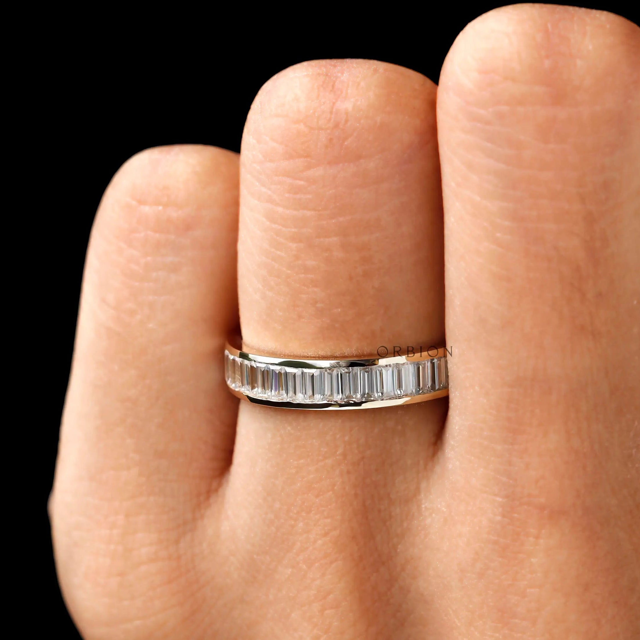 Channel set baguette moissanite eternity band worn on hand