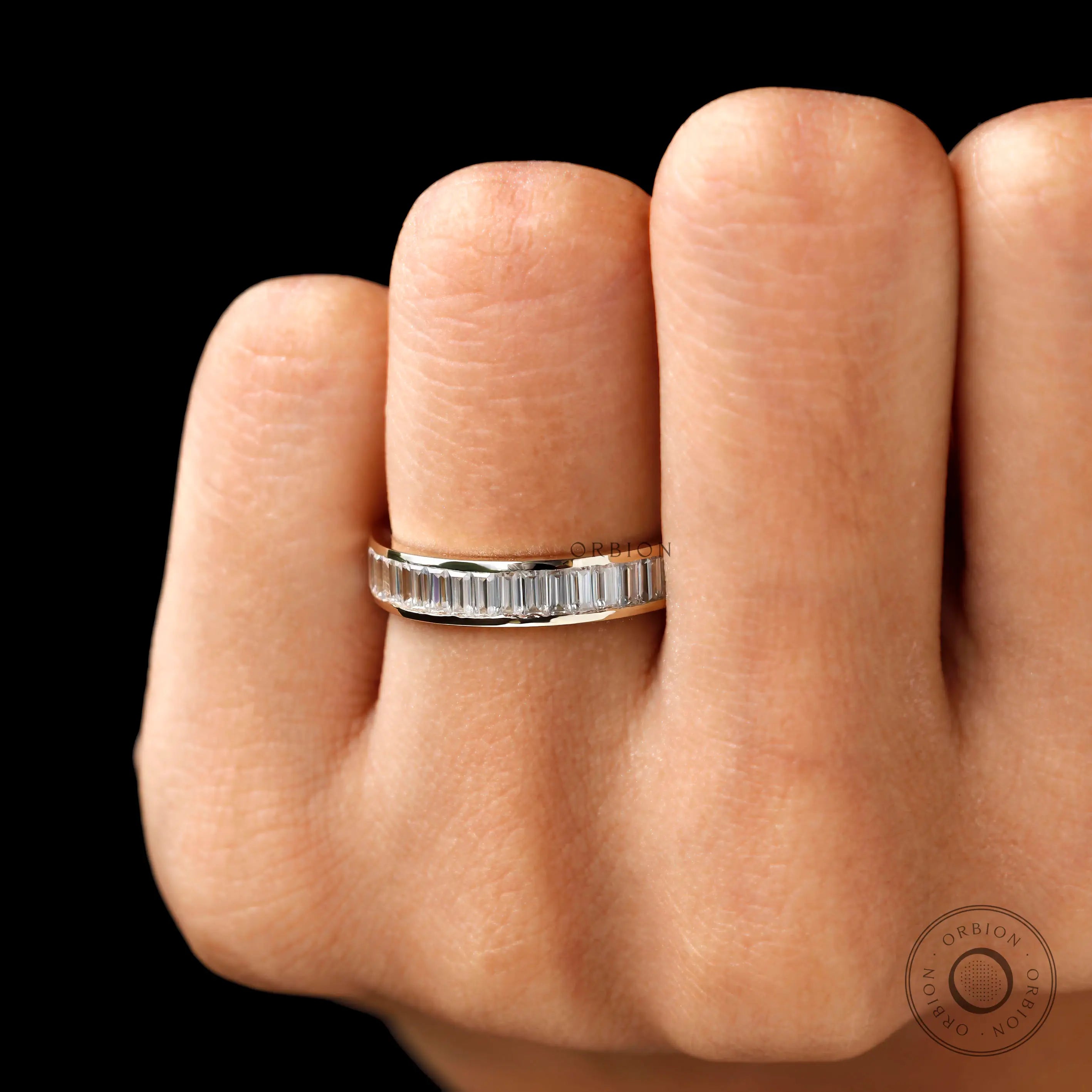 Channel set baguette moissanite eternity band worn on hand