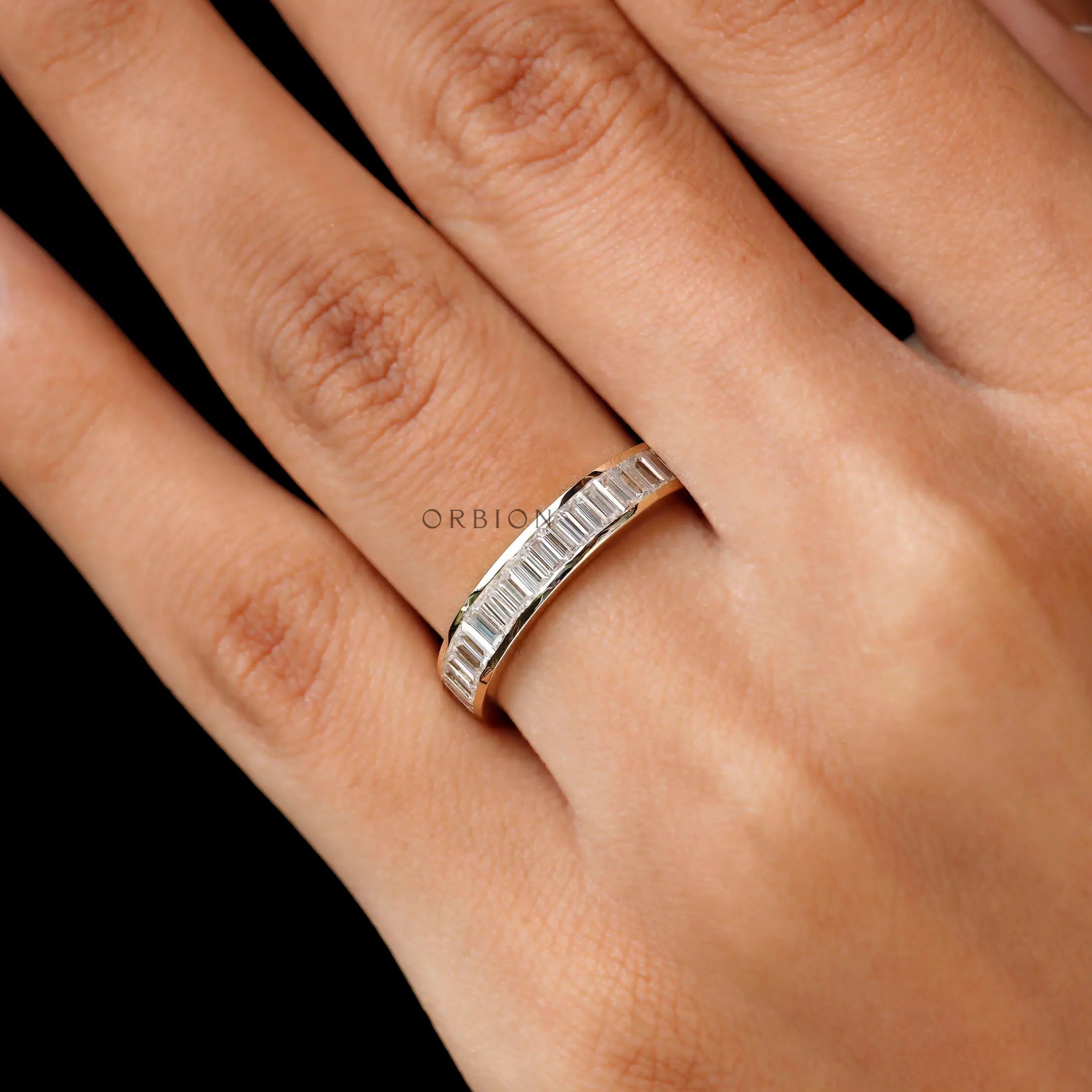 On hand view modern baguette moissanite wedding band
