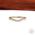 Front view of curved half eternity moissanite wedding band in yellow gold