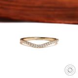 Front view of curved half eternity moissanite wedding band in yellow gold