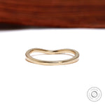 Back view of unique curved wedding band in yellow gold