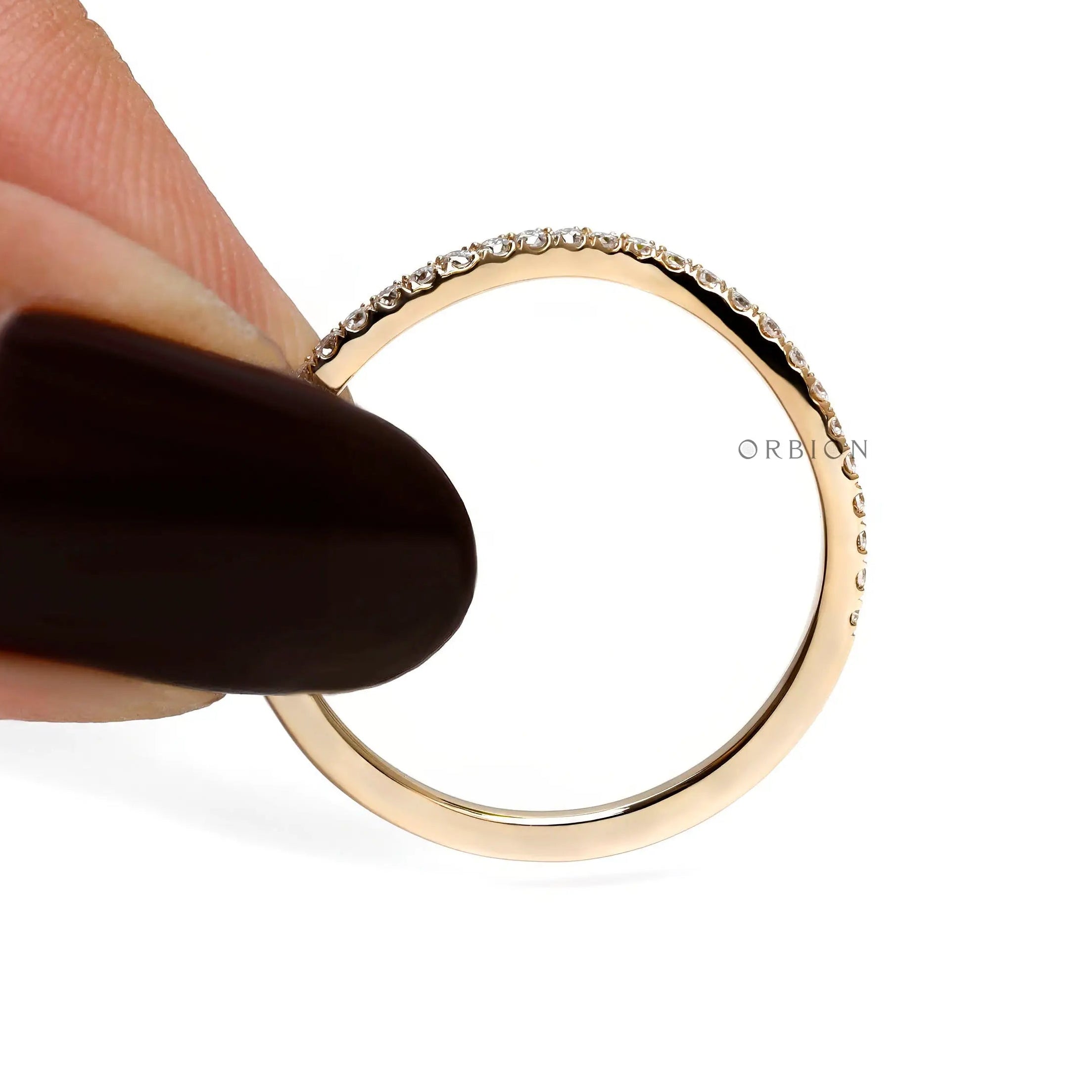 Full side view of slim moissanite curved wedding band