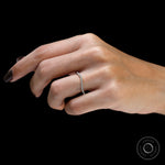 Hand model angled view of unique moissanite curved band