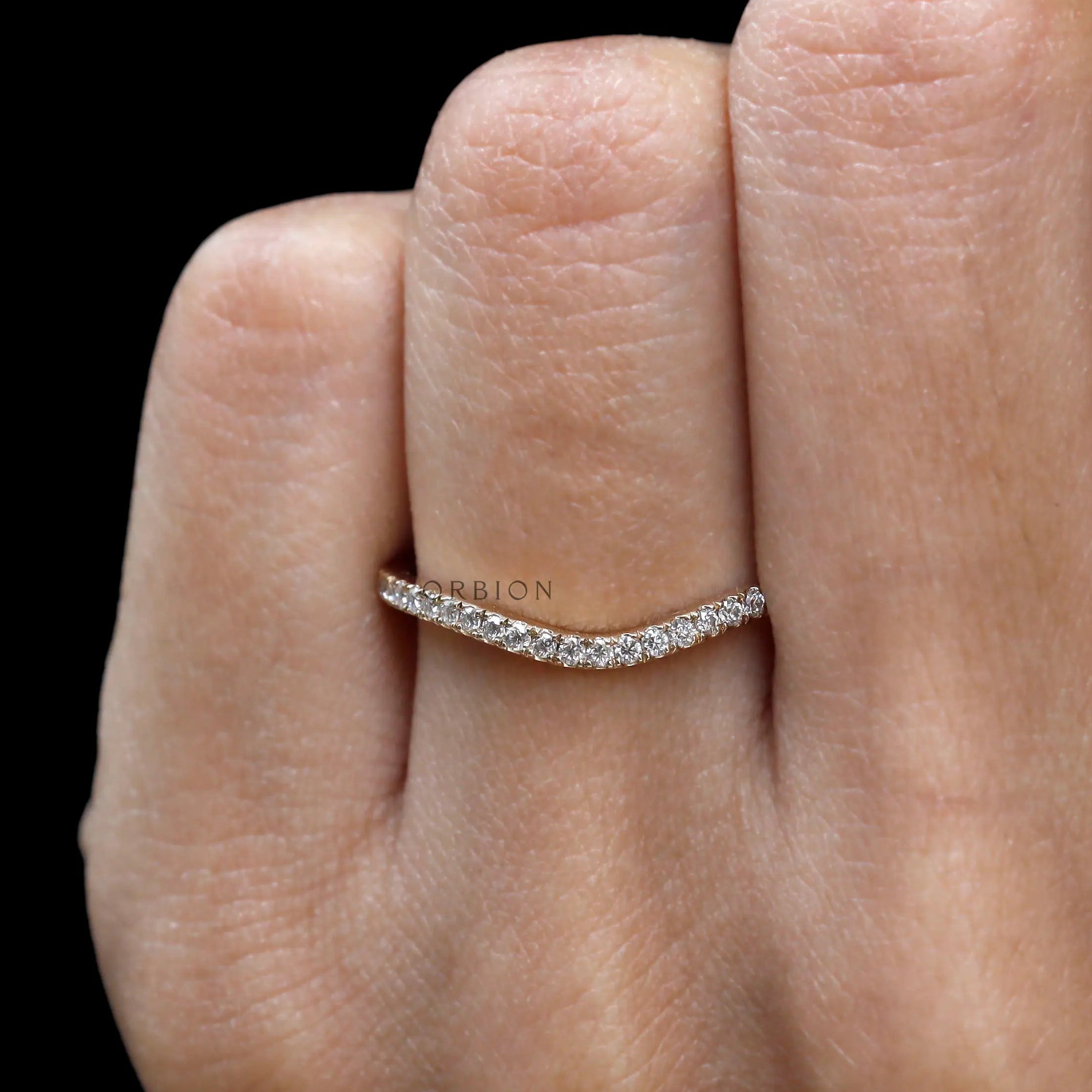 Hand model front view of half eternity curved moissanite band