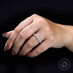 Stackable oval moissanite band on hand highlighting elongated stones