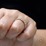 Elegant oval moissanite wedding band shown worn on hand