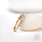 Angled view of oval moissanite wedding band with shared prong setting