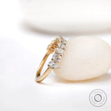 Angled view of oval moissanite wedding band with shared prong setting