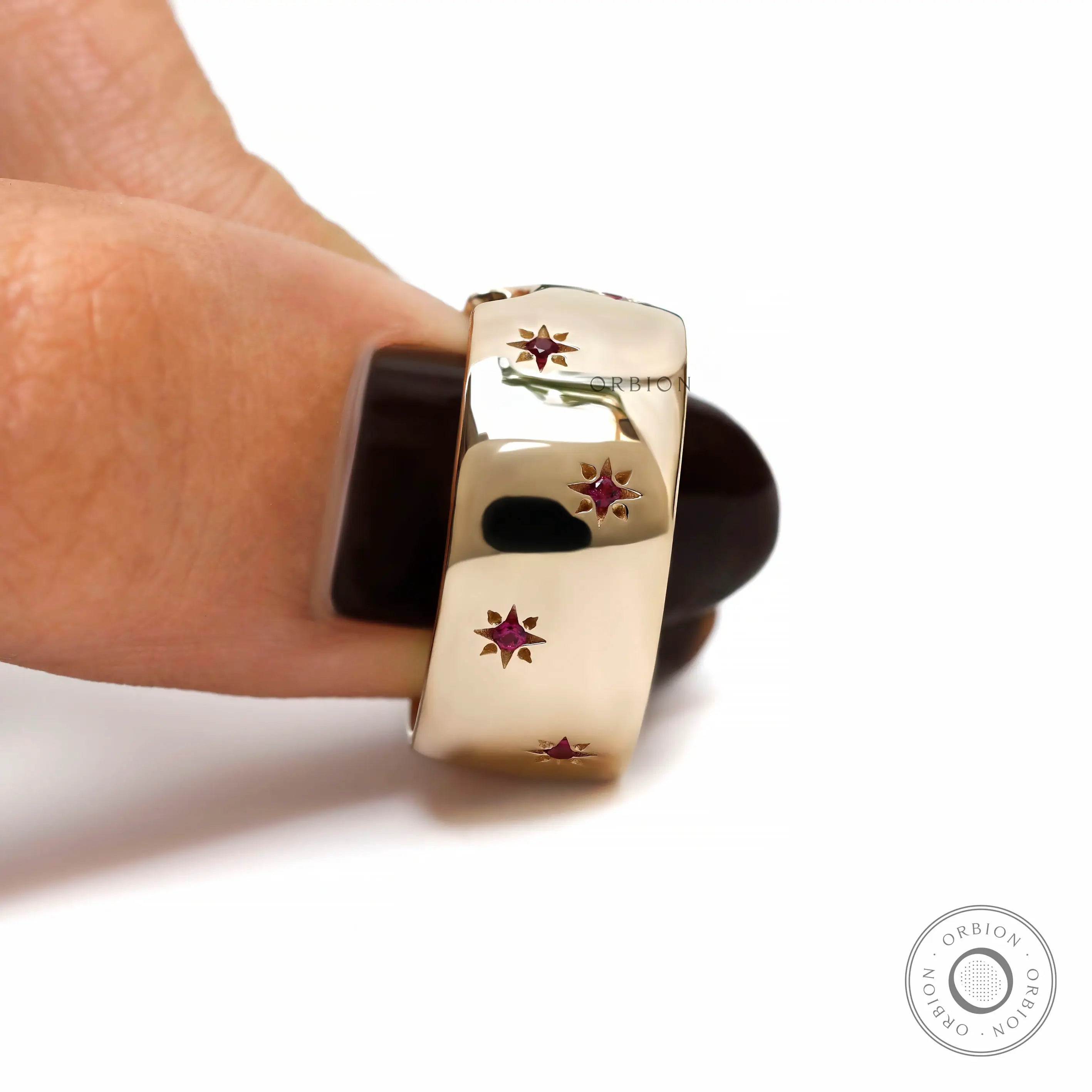 Women wide gold cigar band with red gemstones