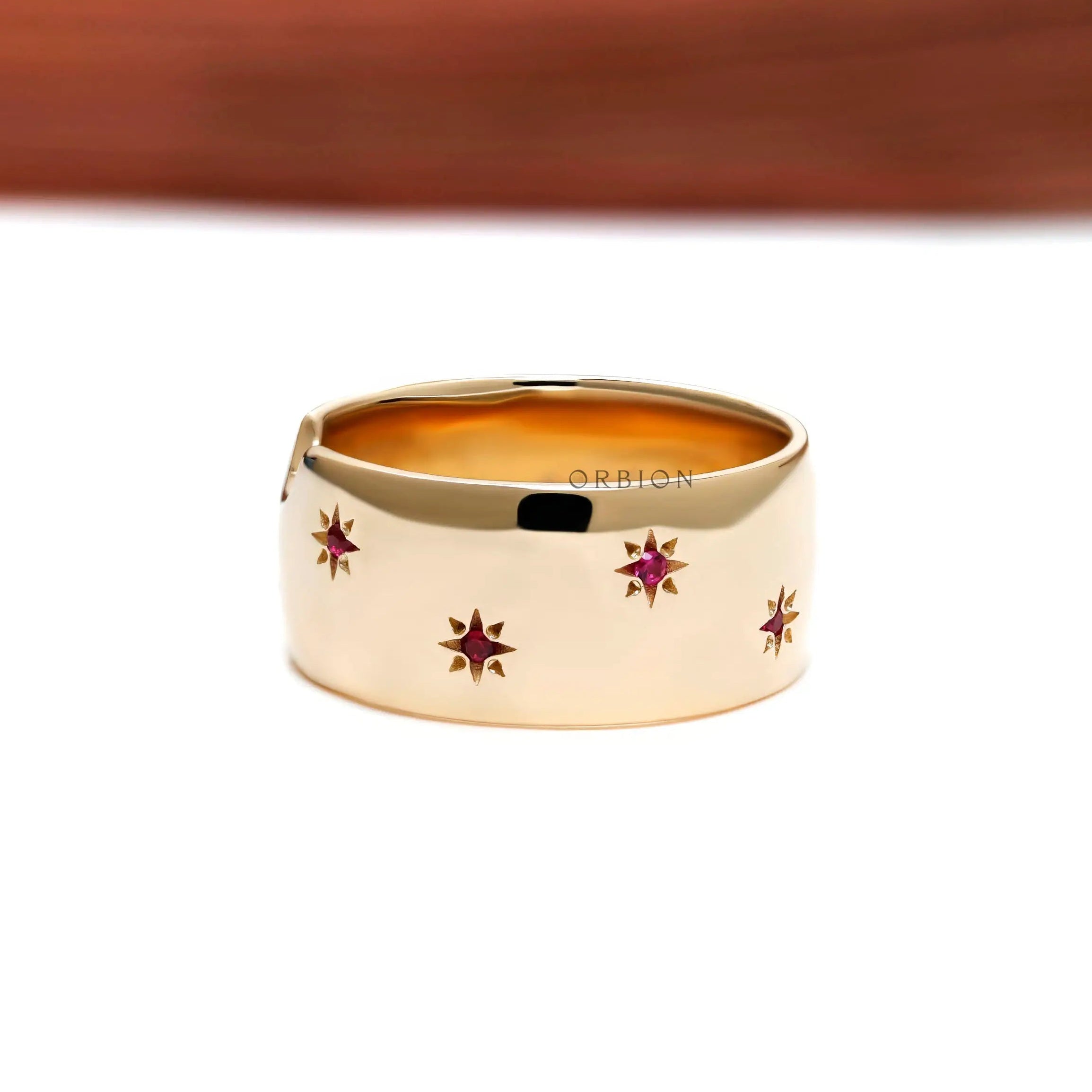 Bold yellow gold dome ring with red ruby stars engraved