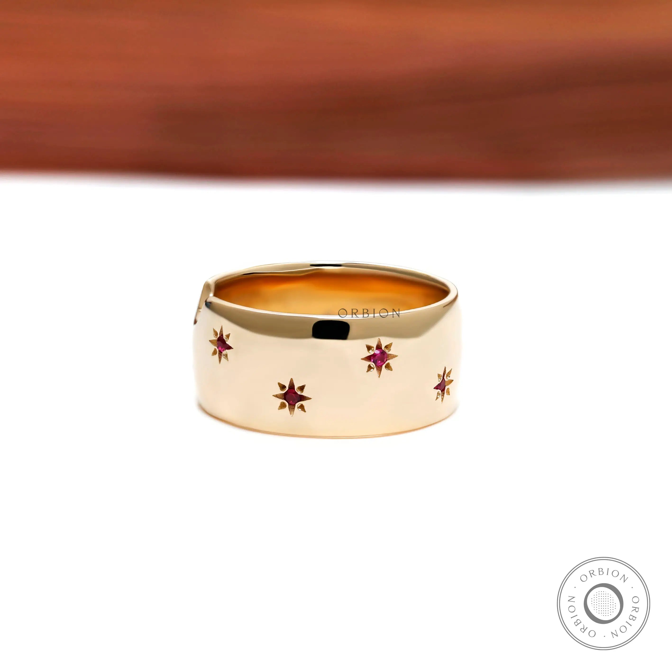 Bold yellow gold dome ring with red ruby stars engraved