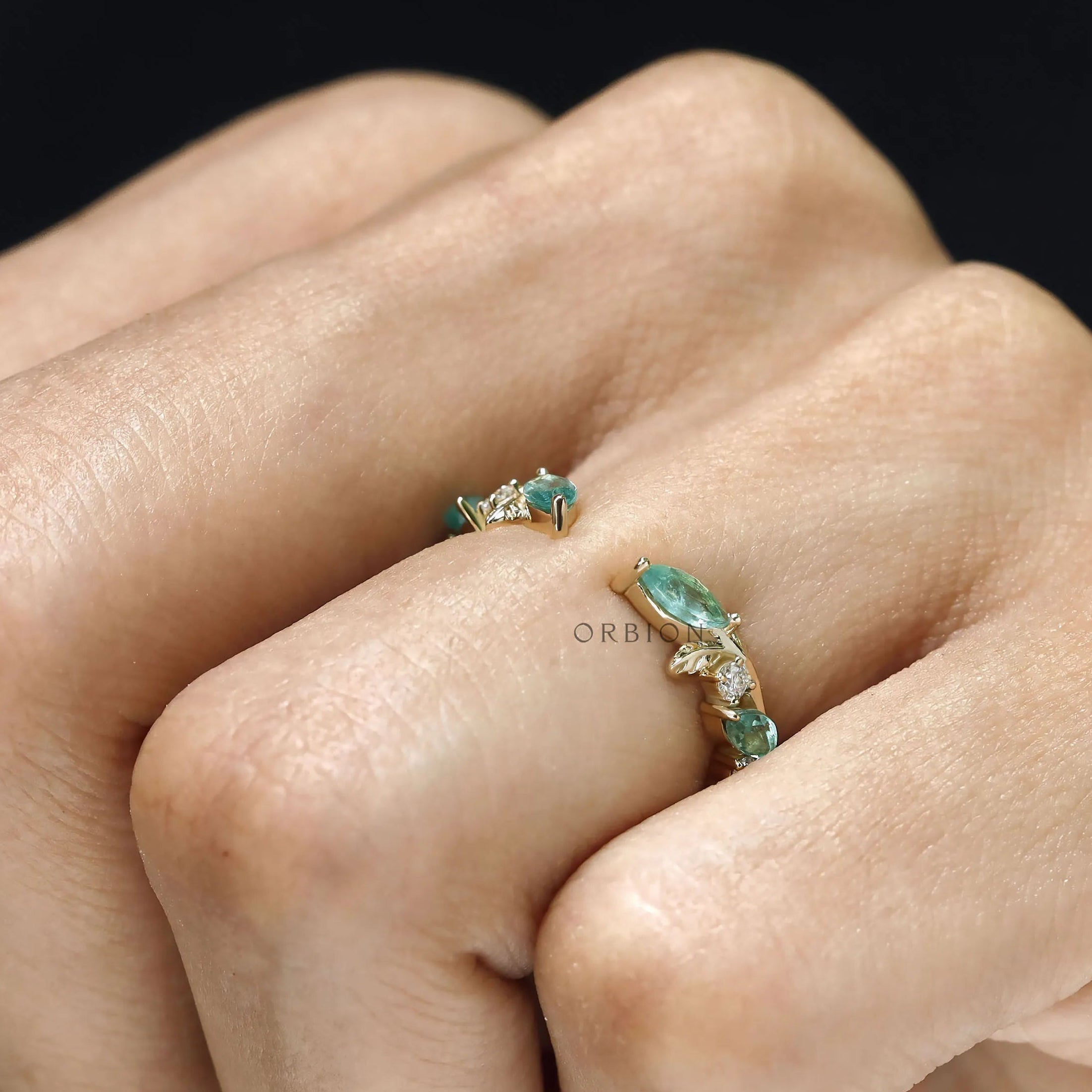 Minimalist wedding ring with leaf and vine motif, green lab gemstones and open yellow gold cuff