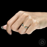 Open cuff stacking band featuring vines and leaves with green lab gemstones in 10k yellow gold