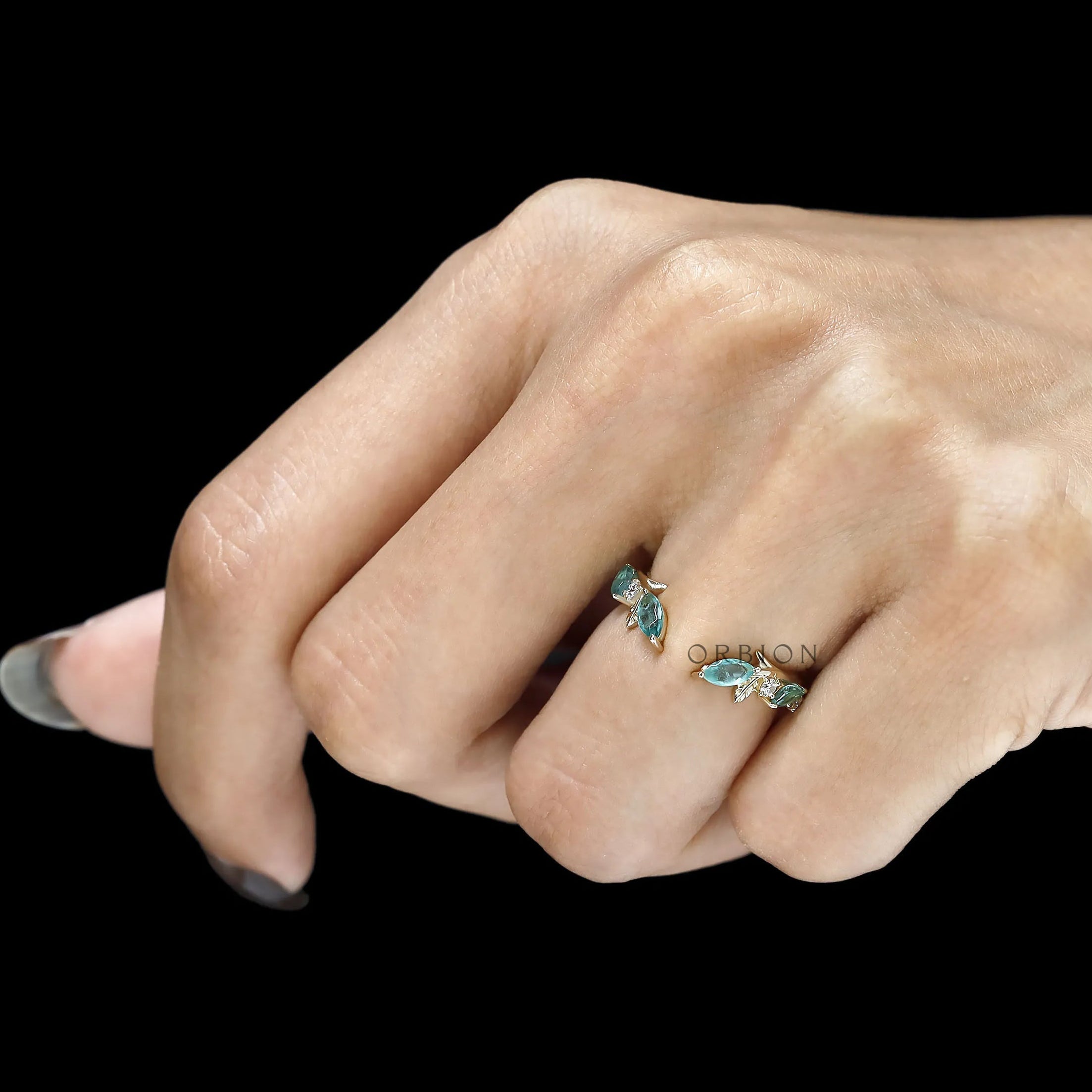 Open cuff stacking band featuring vines and leaves with green lab gemstones in 10k yellow gold