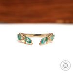 Nature-inspired leaf open cuff stacking band with branch vine design in 10k yellow gold and green lab gemstones