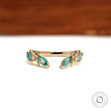 Nature-inspired leaf open cuff stacking band with branch vine design in 10k yellow gold and green lab gemstones