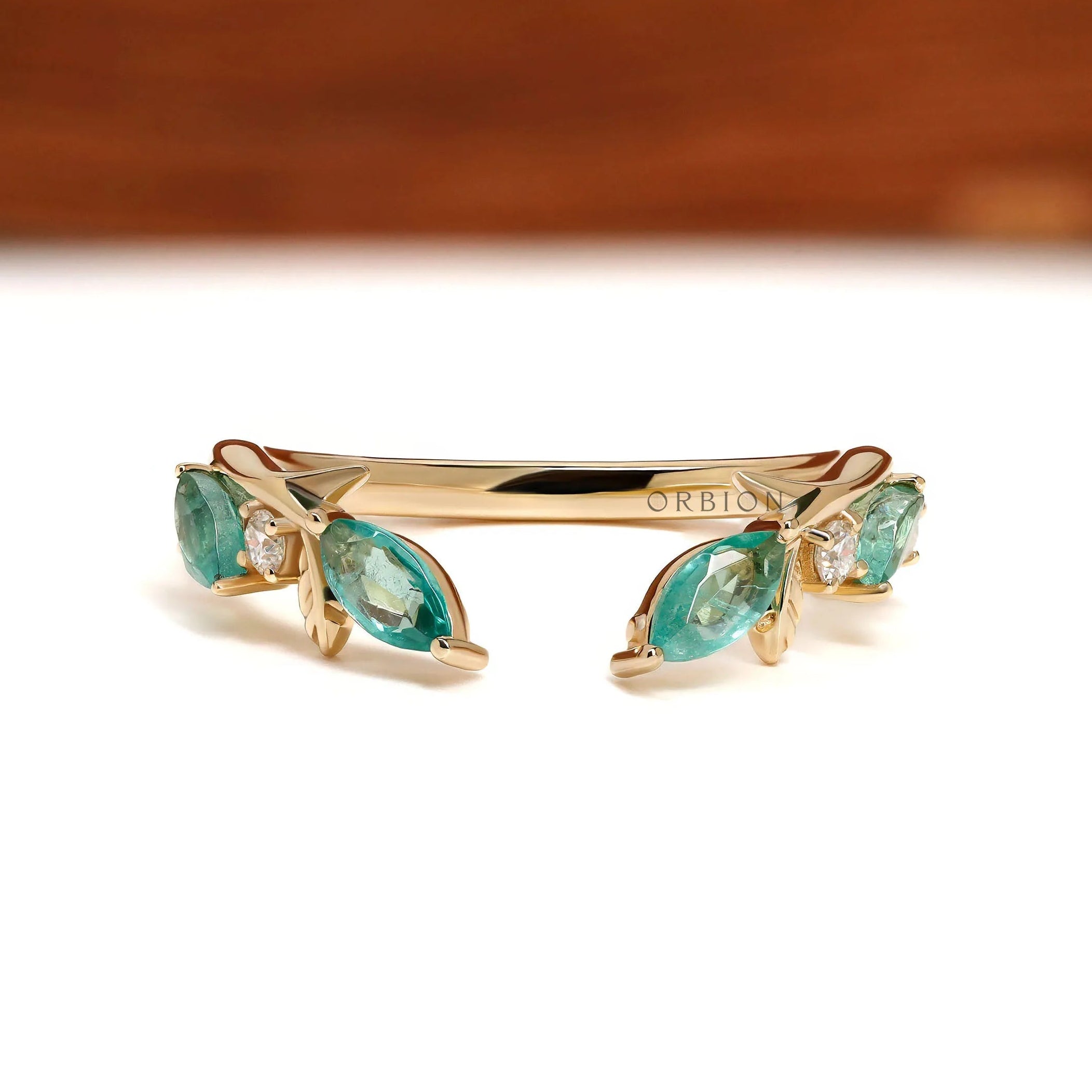 Nature-inspired leaf open cuff stacking band with branch vine design in 10k yellow gold and green lab gemstones