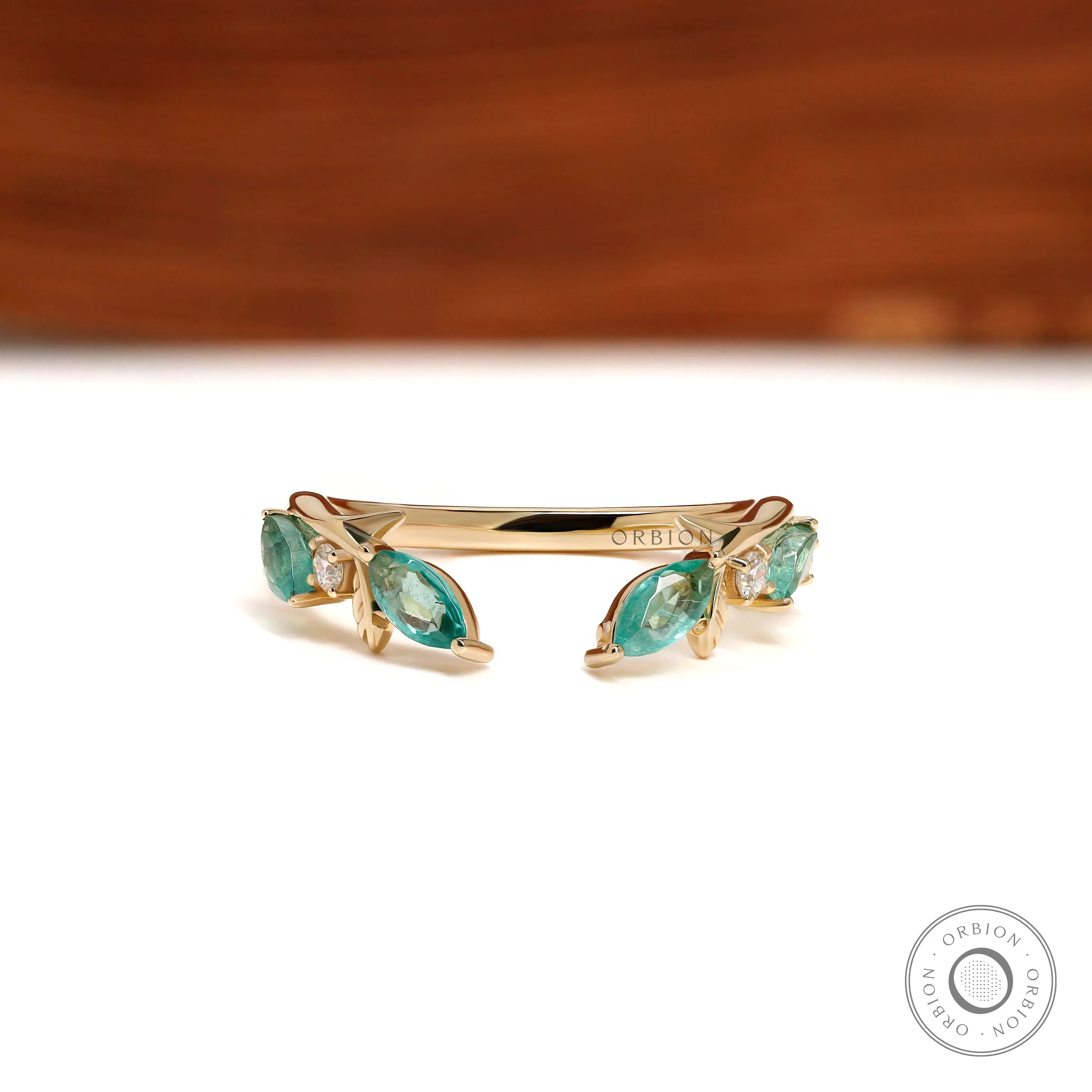 Nature-inspired leaf open cuff stacking band with branch vine design in 10k yellow gold and green lab gemstones