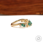 Minimalist leaf-inspired open cuff ring with green lab gemstones in 10k yellow gold for stacking